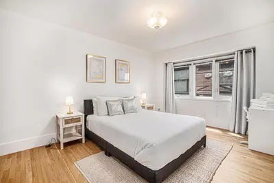 a white bedroom with a bed and a window at Townhouse near Cherry Creek w gym in Denver