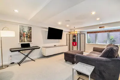 a living room with a couch and a piano at Townhouse near Cherry Creek w gym in Denver