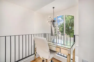 a dining room with a glass table and a white chair at Townhouse near Cherry Creek w gym in Denver