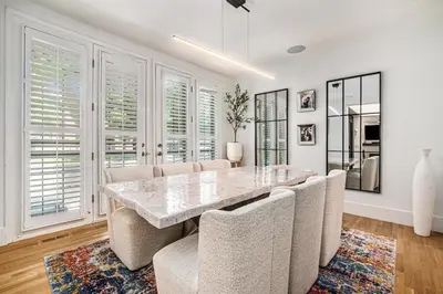 a dining room with a large marble table and chairs at Townhouse near Cherry Creek w gym in Denver