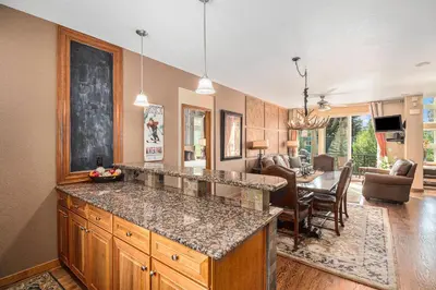 a kitchen with a counter top and a dining room at Fraser retreat w balcony , fireplace & BBQ in Fraser