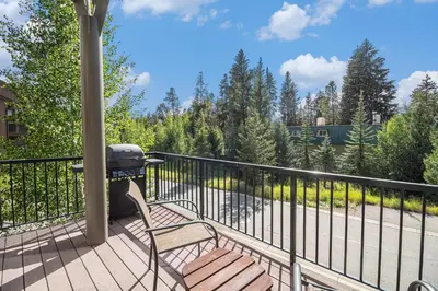 a grill sitting on a deck with a chair at Fraser retreat w balcony , fireplace & BBQ in Fraser