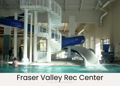 a water slide in a swimming pool in a building at Fraser retreat w balcony , fireplace & BBQ in Fraser