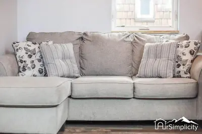 a couch with pillows on it in a living room at Heart of Golden Balcony Near Mtns & Red Rocks in Golden