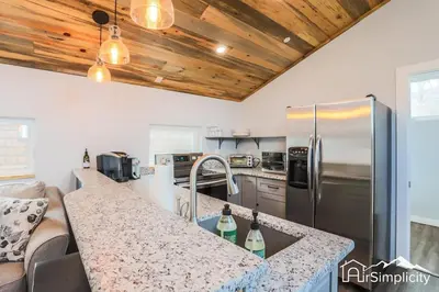 a kitchen with a counter top and a refrigerator at Heart of Golden Balcony Near Mtns & Red Rocks in Golden