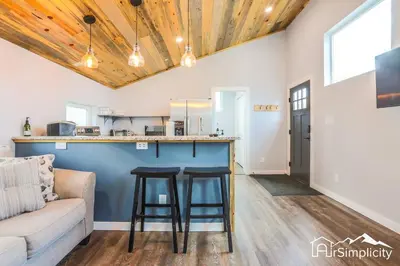 a living room with a couch and a bar at Heart of Golden Balcony Near Mtns & Red Rocks in Golden