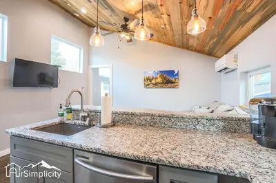 a kitchen with a sink and a tv at Heart of Golden Balcony Near Mtns & Red Rocks in Golden