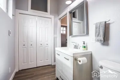 a white bathroom with a sink and a mirror at Heart of Golden Balcony Near Mtns & Red Rocks in Golden