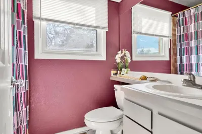 a bathroom with a toilet and a sink at A Denver Oasis 15 Min to the Bronco Stadium 3 Bedroom with a King Suite in Denver