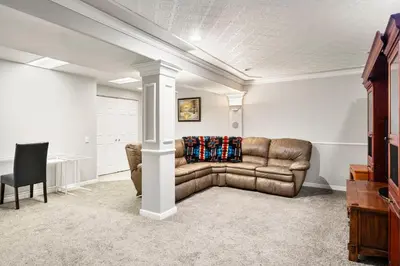 a living room with a couch and a table at A Denver Oasis 15 Min to the Bronco Stadium 3 Bedroom with a King Suite in Denver
