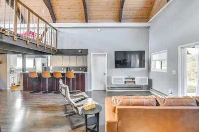 a living room with a couch and a table at 5 Mi to Dtwn Evergreen Mtn-View Escape in Evergreen