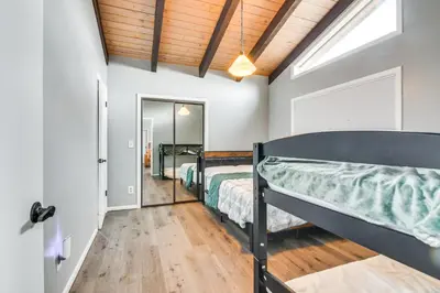 a bedroom with two bunk beds and a window at 5 Mi to Dtwn Evergreen Mtn-View Escape in Evergreen