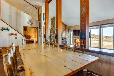 a dining room with a large wooden table and chairs at Walk to Ski Lift and Hiking Granby Ranch Condo! in Granby