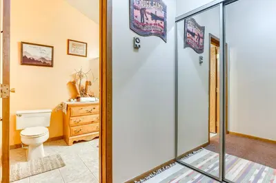 a bathroom with a toilet and a glass shower door at Walk to Ski Lift and Hiking Granby Ranch Condo! in Granby