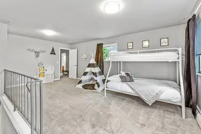 a bedroom with a bunk bed and a staircase at Modern Family Haven Fenced Yrd GrillFirepit in Westminster