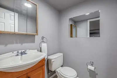 a bathroom with a sink and a toilet and a mirror at Modern Family Haven Fenced Yrd GrillFirepit in Westminster