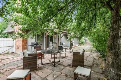 a patio with a table and chairs under a tree at Modern Family Haven Fenced Yrd GrillFirepit in Westminster
