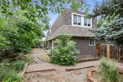 a gray house with a fence and a driveway at Modern Family Haven Fenced Yrd GrillFirepit in Westminster