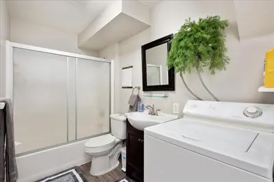 a bathroom with a sink toilet and a mirror at Modern Chic Retreat Near Mtns & Red Rocks Wifi in Wheat Ridge