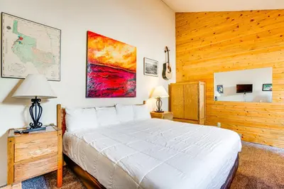 a bedroom with a bed and a map on the wall at 2 Mi to Granby Ranch Studio with Resort Amenities! in Granby
