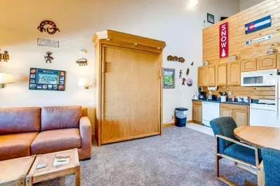 a living room with a couch and a table at 2 Mi to Granby Ranch Studio with Resort Amenities! in Granby