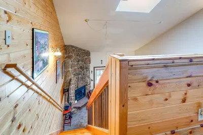 a staircase in a house with a stone wall at 2 Mi to Granby Ranch Studio with Resort Amenities! in Granby