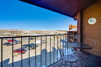 a balcony with a table and chairs and a parking lot at 2 Mi to Granby Ranch Studio with Resort Amenities! in Granby