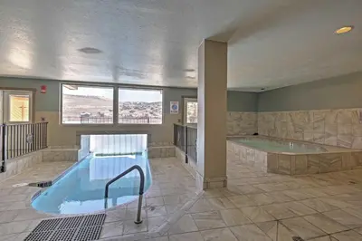 a large bathroom with a hot tub and a swimming pool at 2 Mi to Granby Ranch Studio with Resort Amenities! in Granby