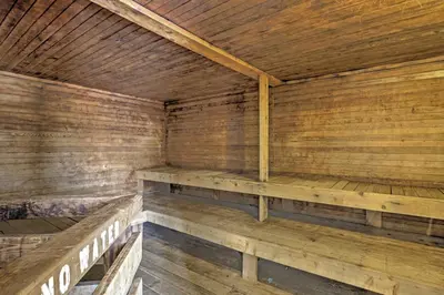 an empty sauna with wooden walls and wooden benches at 2 Mi to Granby Ranch Studio with Resort Amenities! in Granby