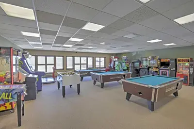 a room with several arcade games and pool tables at 2 Mi to Granby Ranch Studio with Resort Amenities! in Granby