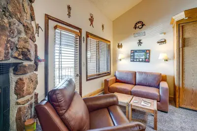 a living room with a couch and a chair at 2 Mi to Granby Ranch Studio with Resort Amenities! in Granby