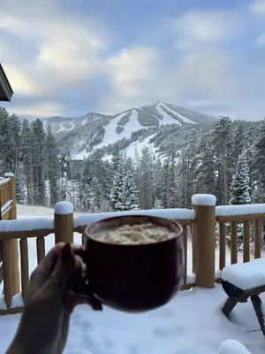 a person holding a bowl of food in the snow at Antler at Lakota 407 home in Winter Park
