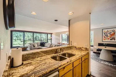a kitchen with a sink and a couch at 1776 Decatur condo in Dillon