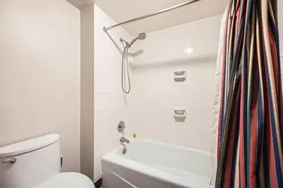 a bathroom with a tub and a toilet and a shower at 1776 Decatur condo in Dillon