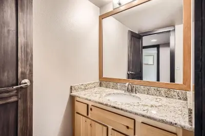 a bathroom with a sink and a mirror at 1776 Decatur condo in Dillon