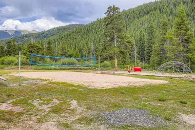 a volley ball net in a field with a forest at 1776 Decatur condo in Dillon