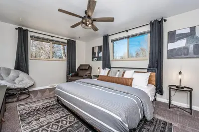 a bedroom with a bed and a ceiling fan at Colorado home near Red Rocks w fenced yard in Wheat Ridge