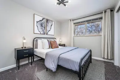 a bedroom with a large bed and a window at Colorado home near Red Rocks w fenced yard in Wheat Ridge