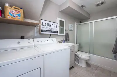 a white bathroom with a sink and a toilet at Colorado home near Red Rocks w fenced yard in Wheat Ridge