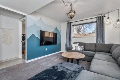 a living room with a couch and a tv at Colorado home near Red Rocks w fenced yard in Wheat Ridge