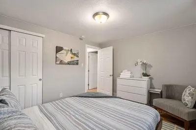 a bedroom with a bed and a chair at Modern Westminster retreat w game room in Westminster