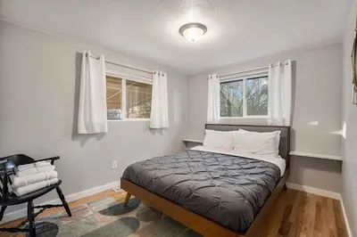a bedroom with a bed and two windows at Modern Westminster retreat w game room in Westminster