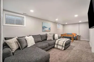 a living room with a couch and a table at Modern Westminster retreat w game room in Westminster