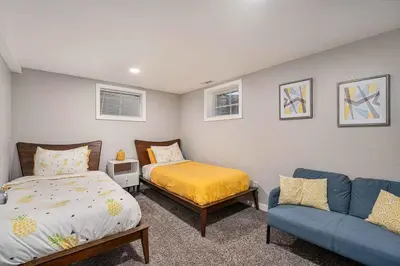 a bedroom with a bed and a blue couch at Modern Westminster retreat w game room in Westminster