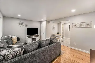 a living room with a couch and a flat screen tv at Modern Westminster retreat w game room in Westminster