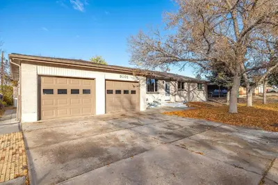 a house with two garage doors and a driveway at Modern Westminster retreat w game room in Westminster