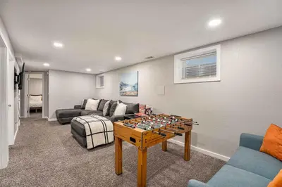 a living room with a chess board on a table at Modern Westminster retreat w game room in Westminster