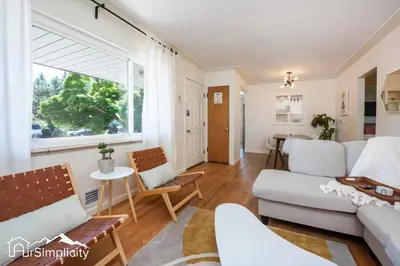 a living room with a couch and a table at Peaceful home w fire pit & game room in Denver