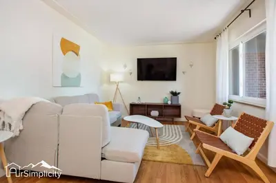 a living room with a couch and a tv at Peaceful home w fire pit & game room in Denver