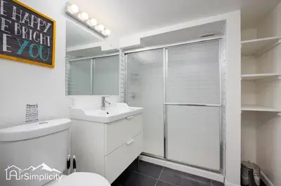 a white bathroom with a sink and a shower at Peaceful home w fire pit & game room in Denver